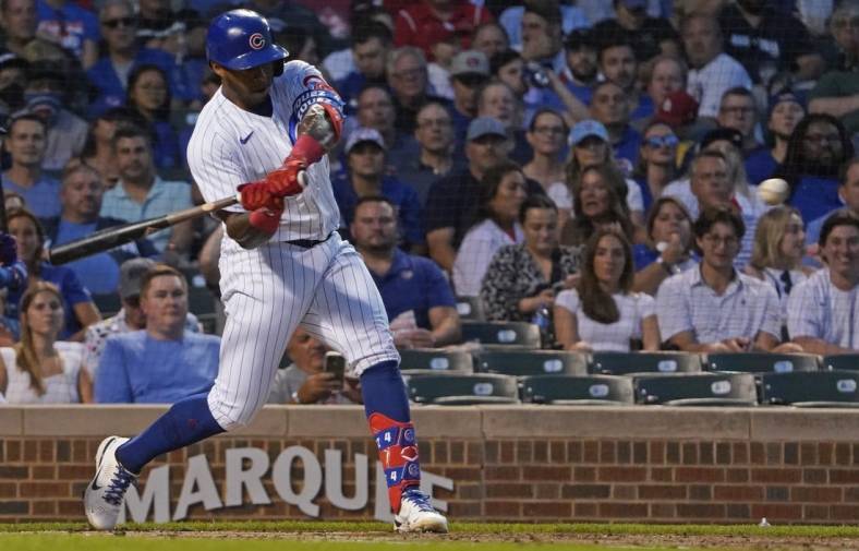 Aug 24, 2022; Chicago, Illinois, USA; Chicago Cubs right fielder Nelson Velazquez (4) hits a double against the St. Louis Cardinals during the second inning at Wrigley Field. Mandatory Credit: David Banks-USA TODAY Sports
