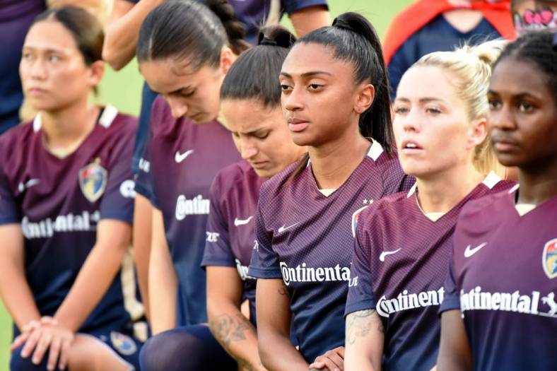 Aug 24, 2022; Cary, North Carolina, USA; North Carolina Courage players look on during the national anthem before the game against Portland Thorns FC at WakeMed Soccer Park. Mandatory Credit: Rob Kinnan-USA TODAY Sports