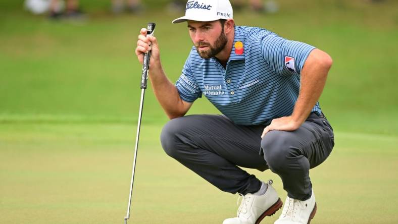 Aug 25, 2022; Atlanta, Georgia, USA; Cameron Young lines a putt on the 1st green during the first round of the TOUR Championship golf tournament. Mandatory Credit: Adam Hagy-USA TODAY Sports