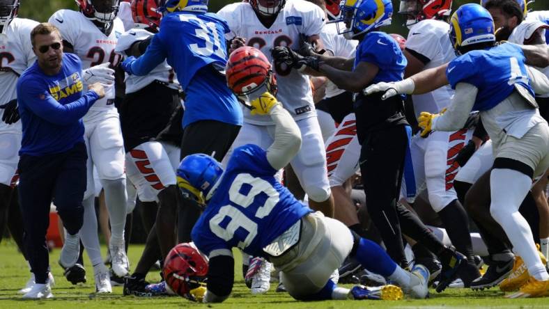 Los Angeles Rams defensive tackle Aaron Donald (99) is knocked to the ground as a third scuffle escalates into a brawl during a joint preseason camp practice between the Cincinnati Bengals and the Los Angeles Rams at Paycor Stadium in Cincinnati on Thursday, Aug. 25, 2022. Practice was ended early after a third scuffle turned into a broader fight between players on both teams.

Cincinnati Bengals Los Angeles Rams Training Camp