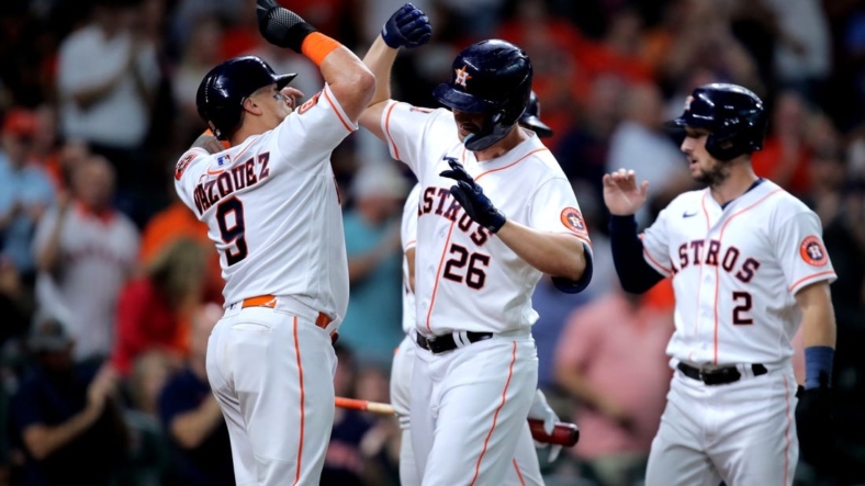 Aug 25, 2022; Houston, Texas, USA; Houston Astros designated hitter Trey Mancini (26) celebrates with Houston Astros catcher Christian Vazquez (9) after hitting a three-run home run against the Minnesota Twins during the first inning at Minute Maid Park. Mandatory Credit: Erik Williams-USA TODAY Sports