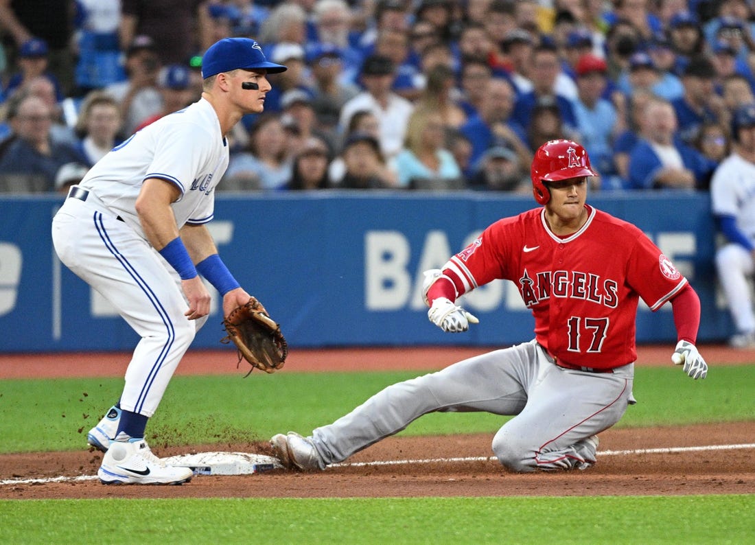 Aug 26, 2022; Toronto, Ontario, CAN;  Los Angeles Angels designated hitter Shohei Ohtani (17) slides safely into third base after hitting a two RBI triple as Toronto Blue Jays third baseman Mark Chapman (26) watches for the ball in the second inning at Rogers Centre. Mandatory Credit: Dan Hamilton-USA TODAY Sports