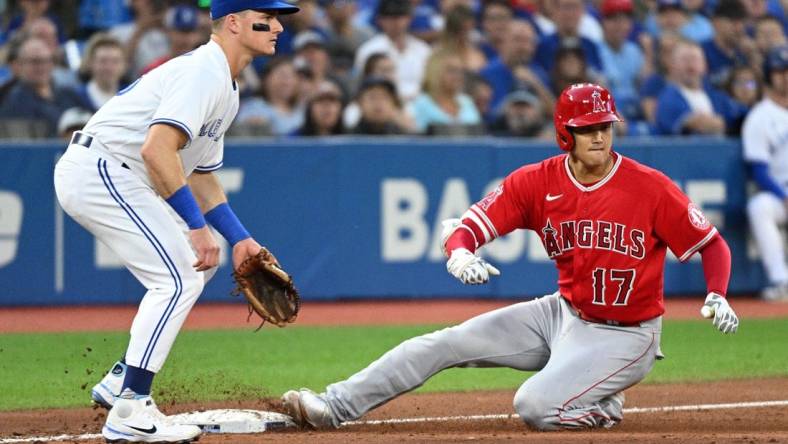 Aug 26, 2022; Toronto, Ontario, CAN;  Los Angeles Angels designated hitter Shohei Ohtani (17) slides safely into third base after hitting a two RBI triple as Toronto Blue Jays third baseman Mark Chapman (26) watches for the ball in the second inning at Rogers Centre. Mandatory Credit: Dan Hamilton-USA TODAY Sports