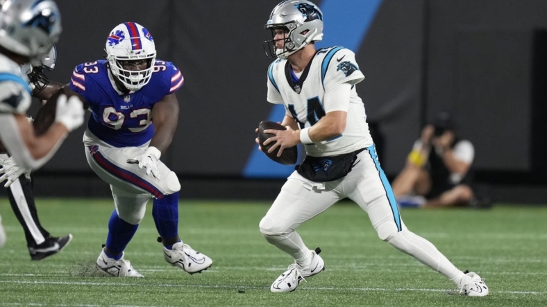 Aug 26, 2022; Charlotte, North Carolina, USA; Carolina Panthers quarterback Sam Darnold (14) is forced from the pocket by the Buffalo Bills defense during the second quarter at Bank of America Stadium. Mandatory Credit: Jim Dedmon-USA TODAY Sports