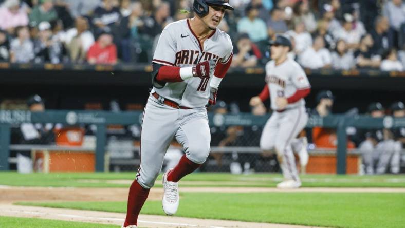 Aug 26, 2022; Chicago, Illinois, USA; Arizona Diamondbacks third baseman Josh Rojas (10) runs to second base after hitting a three-run double against the Chicago White Sox during the second inning at Guaranteed Rate Field. Mandatory Credit: Kamil Krzaczynski-USA TODAY Sports