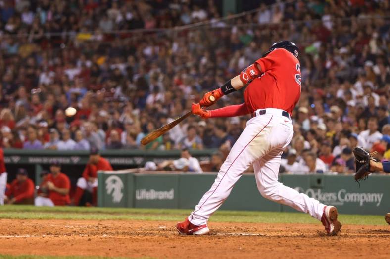 Aug 26, 2022; Boston, Massachusetts, USA; Boston Red Sox catcher Kevin Plawecki (25) hits an RBI during the fifth inning against the Tampa Bay Rays at Fenway Park. Mandatory Credit: Paul Rutherford-USA TODAY Sports