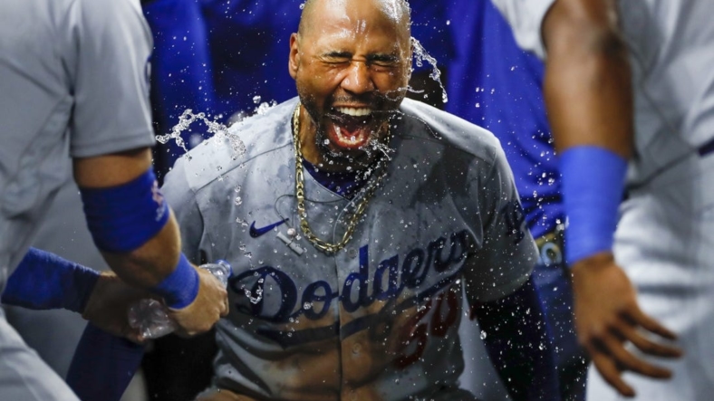 Aug 26, 2022; Miami, Florida, USA; Los Angeles Dodgers right fielder Mookie Betts (50) celebrates as third baseman Justin Turner (10) and second baseman Hanser Alberto (17) pour water over his head after hitting a two-run home run during the seventh inning against the Miami Marlins at loanDepot Park. Mandatory Credit: Sam Navarro-USA TODAY Sports