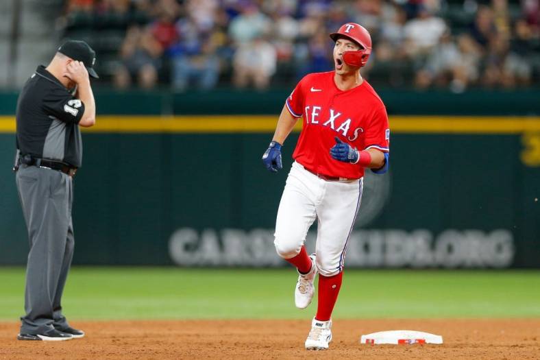 Aug 26, 2022; Arlington, Texas, USA; Aug 26, 2022; Arlington, Texas, USA; (Editors Notes: Caption Correction) Texas Rangers designated hitter Mark Mathias (9) celebrates while rounding the bases after hitting a two-run home run during the third inning against the Detroit Tigers at Globe Life Field. Mandatory Credit: Andrew Dieb-USA TODAY Sports
