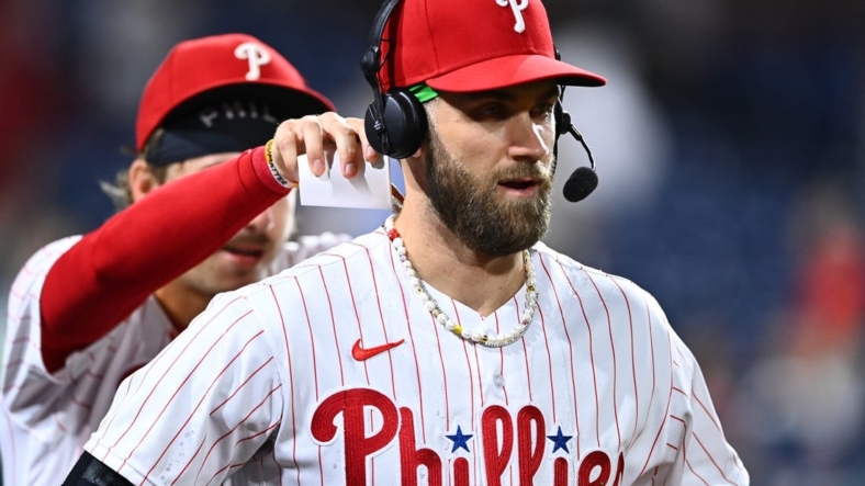 Aug 26, 2022; Philadelphia, Pennsylvania, USA; Philadelphia Phillies outfielder Bryce Harper (3) reacts as infielder Bryson Stott (5) dumps water after the game against the Pittsburgh Pirates at Citizens Bank Park. Mandatory Credit: Kyle Ross-USA TODAY Sports