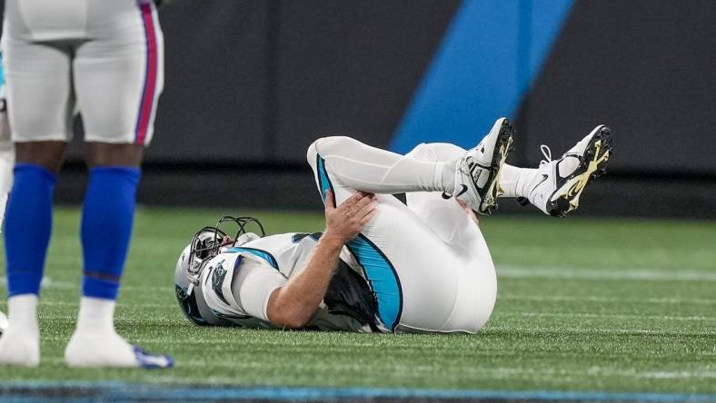 Aug 26, 2022; Charlotte, North Carolina, USA; Carolina Panthers quarterback Sam Darnold (14) lays on the field during the second half against the Buffalo Bills at Bank of America Stadium. Mandatory Credit: Jim Dedmon-USA TODAY Sports