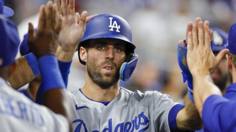 Aug 26, 2022; Miami, Florida, USA; Los Angeles Dodgers second baseman Chris Taylor (3) celebrates after scoring during the tenth inning against the Miami Marlins at loanDepot Park. Mandatory Credit: Sam Navarro-USA TODAY Sports