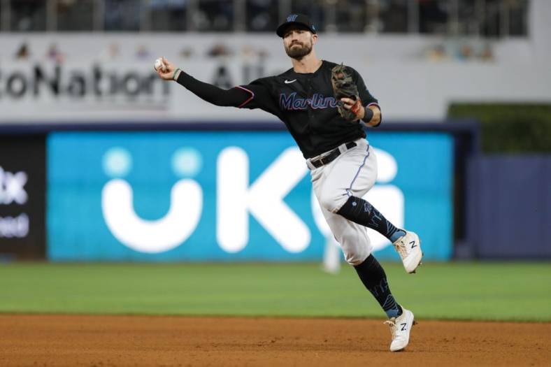 Aug 26, 2022; Miami, Florida, USA; Miami Marlins second baseman Jon Berti (5) throws to first base to retire Los Angeles Dodgers first baseman Freddie Freeman (not pictured) during the fifth inning at loanDepot Park. Mandatory Credit: Sam Navarro-USA TODAY Sports