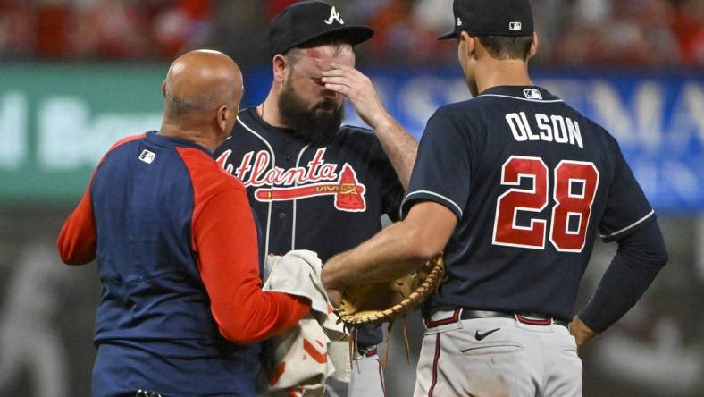 Aug 26, 2022; St. Louis, Missouri, USA;  Atlanta Braves relief pitcher Jackson Stephens (53) is checked on by a trainer and first baseman Matt Olson (28) after he was hit in the head by a line drive hit  by St. Louis Cardinals third baseman Brendan Donovan (not pictured) during the ninth inning at Busch Stadium. Mandatory Credit: Jeff Curry-USA TODAY Sports