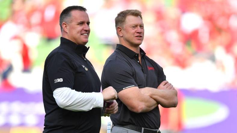 Aug 27, 2022; Dublin, IRELAND; Northwestern Wildcats head coach Pat Fitzgerald, left, and Nebraska Cornhuskers head coach Scott Frost on the field before the Aer Lingus college football series at Aviva Stadium. Mandatory Credit: Brendan Moran-USA TODAY Sports