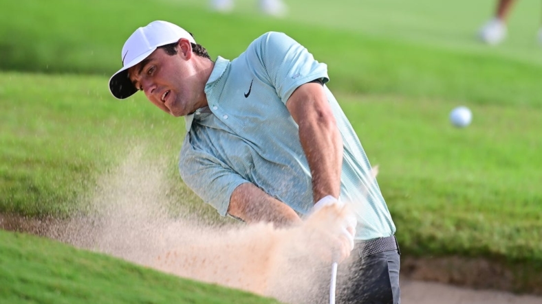 Aug 27, 2022; Atlanta, Georgia, USA; Scottie Scheffler hits from the sand on the 8th hole during the third round of the TOUR Championship golf tournament. Mandatory Credit: Adam Hagy-USA TODAY Sports