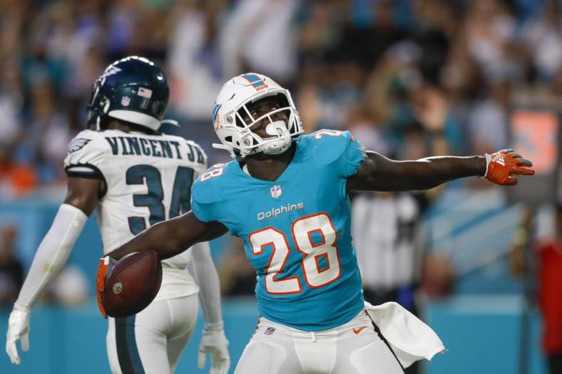 Aug 27, 2022; Miami Gardens, Florida, USA; Miami Dolphins running back Sony Michel (28) celebrates after scoring a touchdown during the first quarter against the Philadelphia Eagles at Hard Rock Stadium. Mandatory Credit: Sam Navarro-USA TODAY Sports