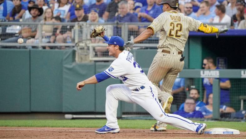 Aug 27, 2022; Kansas City, Missouri, USA; Kansas City Royals first baseman Nick Pratto (32) bobbles a throw to first base as San Diego Padres right fielder Juan Soto (22) reaches safely in the third inning at Kauffman Stadium. Mandatory Credit: Denny Medley-USA TODAY Sports