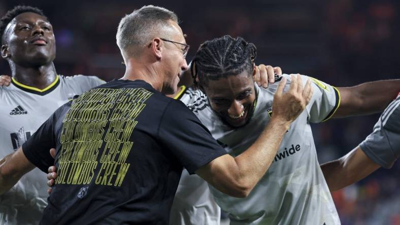 Aug 27, 2022; Cincinnati, Ohio, USA;  Columbus Crew SC head coach Caleb Porter (left) hugs defender Steven Moreira as they celebrate after the game against FC Cincinnati at TQL Stadium. Mandatory Credit: Aaron Doster-USA TODAY Sports