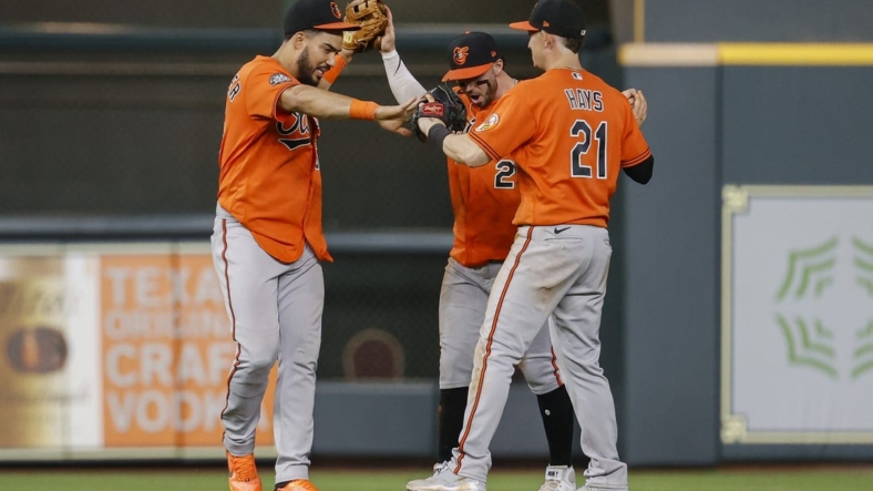 Aug 27, 2022; Houston, Texas, USA; Baltimore Orioles left fielder Anthony Santander (25) celebrates with center fielder Ryan McKenna (26) and right fielder Austin Hays (21) after the Orioles defeated the Houston Astros at Minute Maid Park. Mandatory Credit: Troy Taormina-USA TODAY Sports