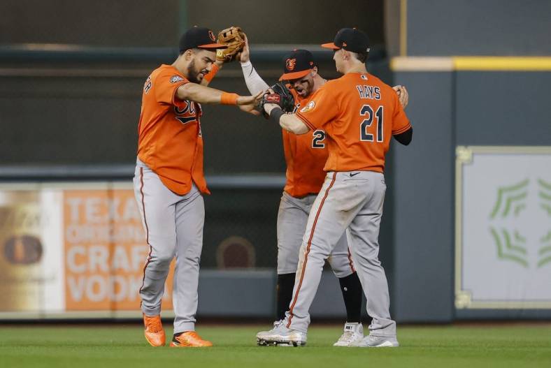 Aug 27, 2022; Houston, Texas, USA; Baltimore Orioles left fielder Anthony Santander (25) celebrates with center fielder Ryan McKenna (26) and right fielder Austin Hays (21) after the Orioles defeated the Houston Astros at Minute Maid Park. Mandatory Credit: Troy Taormina-USA TODAY Sports