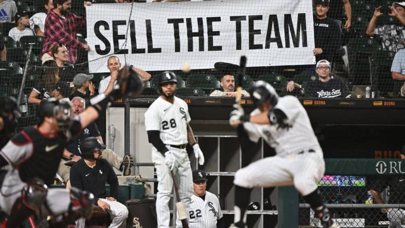 Aug 27, 2022; Chicago, Illinois, USA;  Frustrated Chicago White Sox fans hold up a sign urging to sell the team as outfielder AJ Pollock (18) bats in the ninth inning against the Arizona Diamondbacks at Guaranteed Rate Field. Arizona defeated Chicago 10-5. Mandatory Credit: Jamie Sabau-USA TODAY Sports