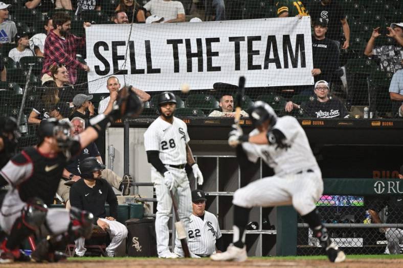 Aug 27, 2022; Chicago, Illinois, USA;  Frustrated Chicago White Sox fans hold up a sign urging to sell the team as outfielder AJ Pollock (18) bats in the ninth inning against the Arizona Diamondbacks at Guaranteed Rate Field. Arizona defeated Chicago 10-5. Mandatory Credit: Jamie Sabau-USA TODAY Sports