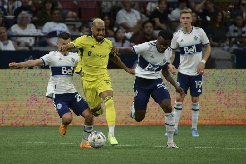Aug 27, 2022; Vancouver, British Columbia, CAN;  Nashville SC midfielder Hany Mukhtar (10) controls the ball against Vancouver Whitecaps FC defender Javain Brown (23) during the first half at BC Place. Mandatory Credit: Anne-Marie Sorvin-USA TODAY Sports