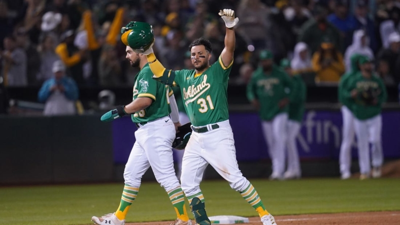 Aug 27, 2022; Oakland, California, USA; Oakland Athletics third baseman Vimael Machin (31) celebrates after defeating the New York Yankees in eleven innings at RingCentral Coliseum. Mandatory Credit: Cary Edmondson-USA TODAY Sports
