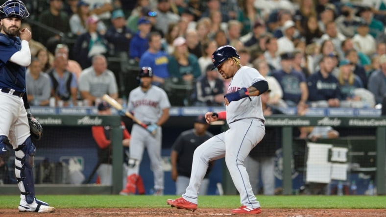 Aug 27, 2022; Seattle, Washington, USA; Cleveland Guardians third baseman Jose Ramirez (11) scores a run on a sacrifice fly hit by second baseman Andres Gimenez (not pictured) against the Seattle Mariners during the eighth inning at T-Mobile Park. Mandatory Credit: Steven Bisig-USA TODAY Sports