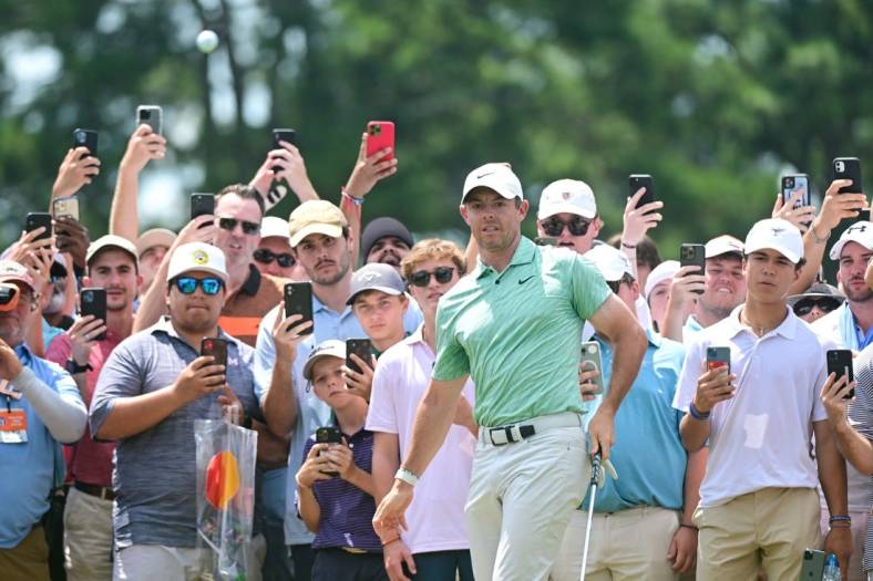Aug 28, 2022; Atlanta, Georgia, USA; Rory McIlroy watches his chip attempt onto the 1st green during the final round of the TOUR Championship golf tournament. Mandatory Credit: Adam Hagy-USA TODAY Sports