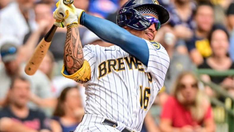 Aug 28, 2022; Milwaukee, Wisconsin, USA;  Milwaukee Brewers second baseman Kolten Wong (16) hits a 2-run home run in the fifth inning against the Chicago Cubs at American Family Field. Mandatory Credit: Benny Sieu-USA TODAY Sports