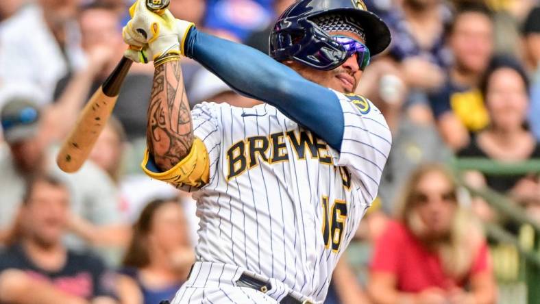 Aug 28, 2022; Milwaukee, Wisconsin, USA;  Milwaukee Brewers second baseman Kolten Wong (16) hits a 2-run home run in the fifth inning against the Chicago Cubs at American Family Field. Mandatory Credit: Benny Sieu-USA TODAY Sports