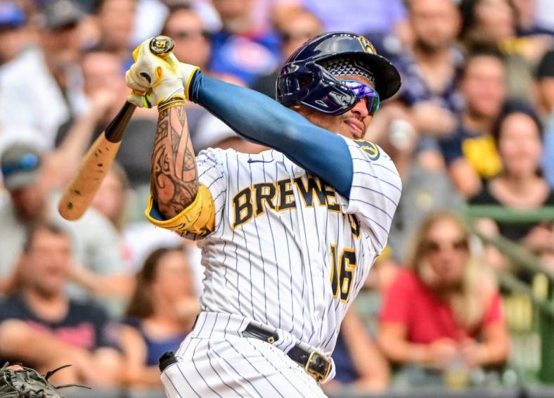 Aug 28, 2022; Milwaukee, Wisconsin, USA;  Milwaukee Brewers second baseman Kolten Wong (16) hits a 2-run home run in the fifth inning against the Chicago Cubs at American Family Field. Mandatory Credit: Benny Sieu-USA TODAY Sports