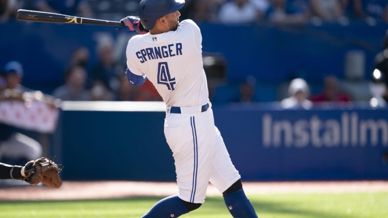 Aug 28, 2022; Toronto, Ontario, CAN; Toronto Blue Jays center fielder George Springer (4) hits a home run against the Los Angeles Angels during the ninth inning at Rogers Centre. Mandatory Credit: Nick Turchiaro-USA TODAY Sports