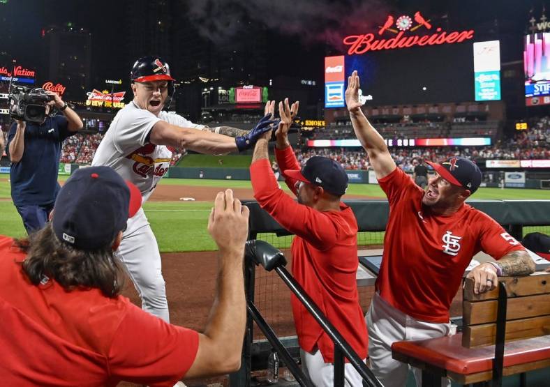 Aug 28, 2022; St. Louis, Missouri, USA;  St. Louis Cardinals left fielder Tyler O'Neill (27) celebrates with manager Oliver Marmol (37) bench coach Skip Schumaker (55) and hitting coach Jeff Albert (54) after hitting a go ahead three run home run against the Atlanta Braves during the eighth inning at Busch Stadium. Mandatory Credit: Jeff Curry-USA TODAY Sports