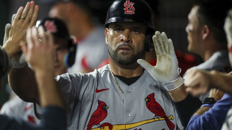 Aug 29, 2022; Cincinnati, Ohio, USA; St. Louis Cardinals first baseman Albert Pujols (5) high fives teammates after hitting a two-run home run against the Cincinnati Reds in the third inning at Great American Ball Park. Mandatory Credit: Katie Stratman-USA TODAY Sports