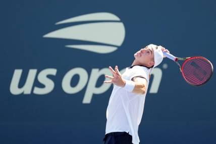 Aug 30, 2022; Flushing, NY, USA; John Isner of the United States serves to Federico Delbonis of Argentina on day two of the 2022 U.S. Open tennis tournament at USTA Billie Jean King National Tennis Center. Mandatory Credit: Danielle Parhizkaran-USA TODAY Sports