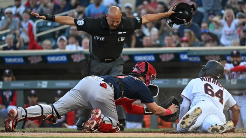 Aug 30, 2022; Minneapolis, Minnesota, USA; Minnesota Twins designated hitter Jose Miranda (64) scores a run ahead of the tag by Boston Red Sox catcher Reese McGuire (3) on a double hit by outfielder Nick Gordon (not pictured) during the first inning at Target Field. Mandatory Credit: Nick Wosika-USA TODAY Sports