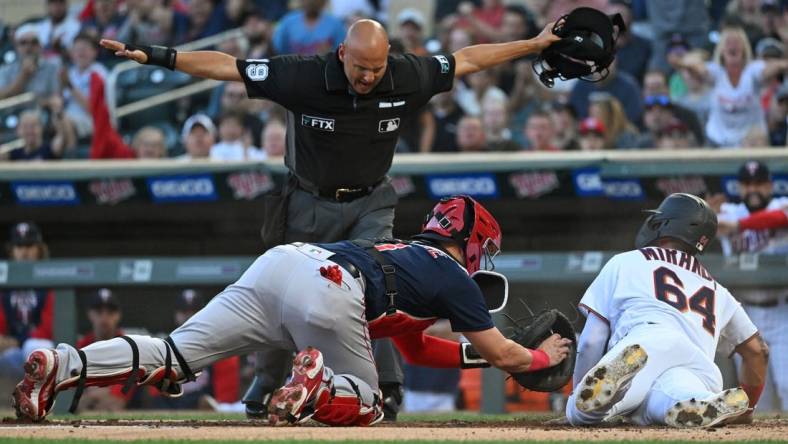 Aug 30, 2022; Minneapolis, Minnesota, USA; Minnesota Twins designated hitter Jose Miranda (64) scores a run ahead of the tag by Boston Red Sox catcher Reese McGuire (3) on a double hit by outfielder Nick Gordon (not pictured) during the first inning at Target Field. Mandatory Credit: Nick Wosika-USA TODAY Sports