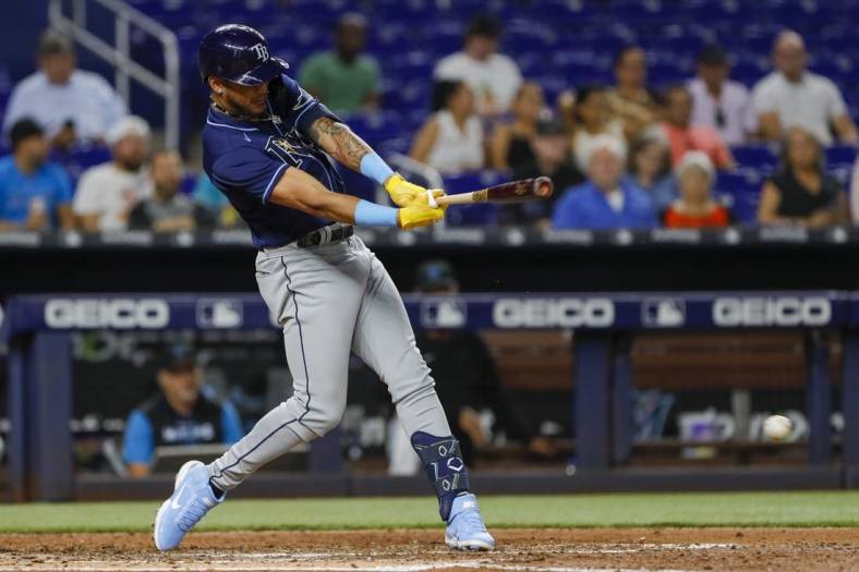 Aug 30, 2022; Miami, Florida, USA; Tampa Bay Rays center fielder Jose Siri (22) hits a single during the fifth inning against the Miami Marlins at loanDepot Park. Mandatory Credit: Sam Navarro-USA TODAY Sports