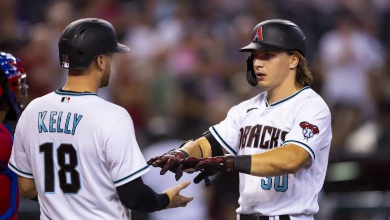 Aug 30, 2022; Phoenix, Arizona, USA; Arizona Diamondbacks outfielder Jake McCarthy (right) celebrates with teammate Carson Kelly after hitting a three run home run in the fourth inning against the Philadelphia Phillies at Chase Field. Mandatory Credit: Mark J. Rebilas-USA TODAY Sports