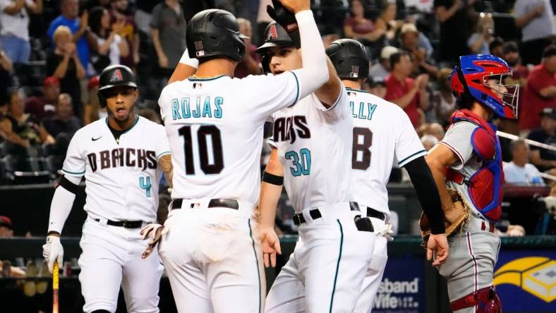 Aug 30, 2022; Phoenix, Arizona, USA; Arizona Diamondbacks Jake McCarthy (30) high-fives Josh Rojas (10) after hitting a three-run home run against the Philadelphia Phillies in the fourth inning at Chase Field. Mandatory Credit: Rob Schumacher-Arizona Republic

Mlb Phillies At Diamondbacks