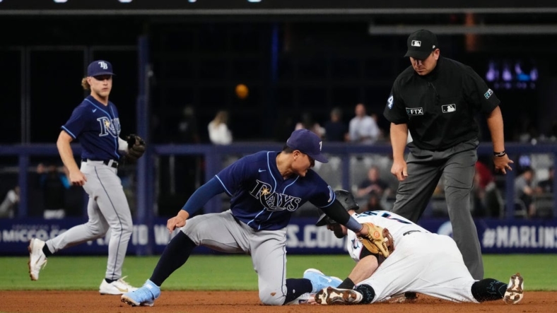 Aug 31, 2022; Miami, Florida, USA; Miami Marlins third baseman Jon Berti (5) steals second base ahead of the tag of Tampa Bay Rays second baseman Brandon Lowe (8) in the fourth inning at loanDepot park. Mandatory Credit: Jasen Vinlove-USA TODAY Sports