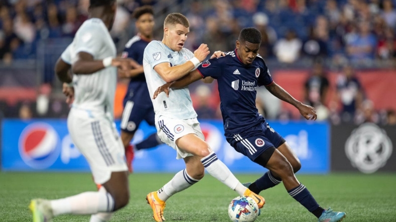 Aug 31, 2022; Foxborough, Massachusetts, USA; New England Revolution midfielder Maciel (13) defends Chicago Fire FC forward Christopher Mueller (8) during the first half at Gillette Stadium. Mandatory Credit: Paul Rutherford-USA TODAY Sports