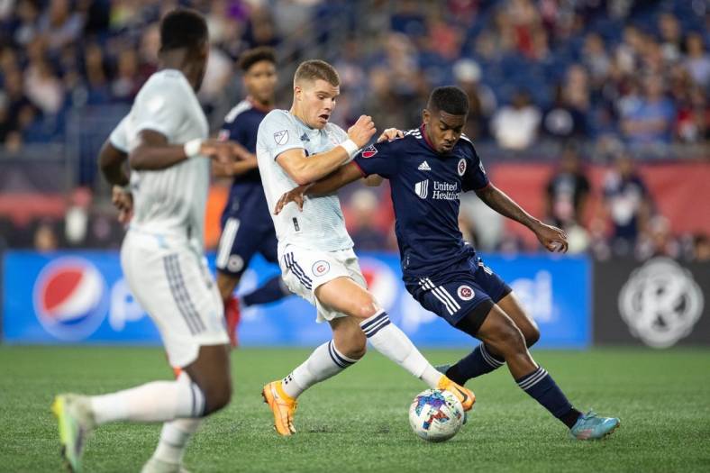 Aug 31, 2022; Foxborough, Massachusetts, USA; New England Revolution midfielder Maciel (13) defends Chicago Fire FC forward Christopher Mueller (8) during the first half at Gillette Stadium. Mandatory Credit: Paul Rutherford-USA TODAY Sports