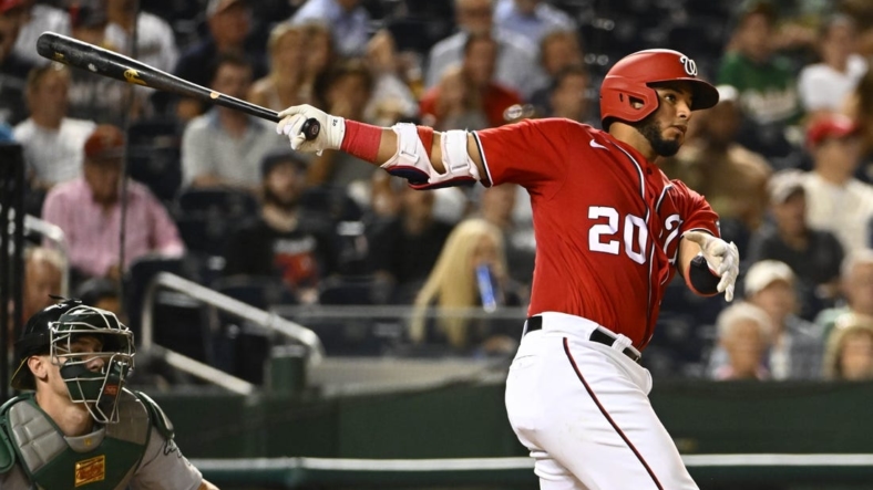 Aug 31, 2022; Washington, District of Columbia, USA; Washington Nationals catcher Keibert Ruiz (20) hits a single against the Oakland Athletics during the fourth inning at Nationals Park. Mandatory Credit: Brad Mills-USA TODAY Sports