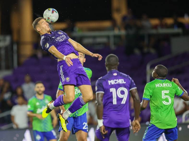 Aug 31, 2022; Orlando, Florida, USA;  Orlando City forward Ercan Kara (9) heads the ball against the Seattle Sounders in the second half at Exploria Stadium. Mandatory Credit: Nathan Ray Seebeck-USA TODAY Sports