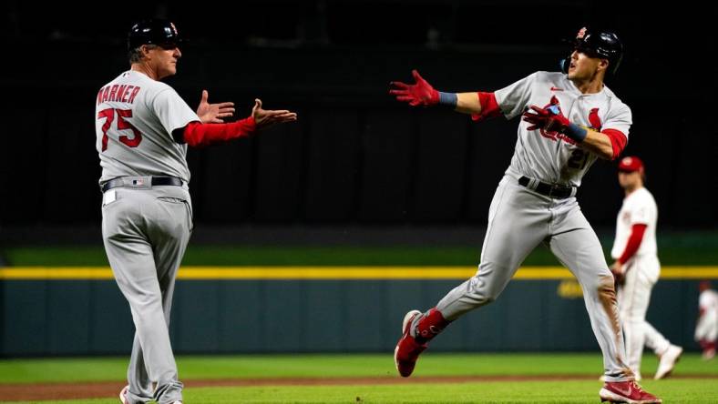 St. Louis Cardinals right fielder Lars Nootbaar (21) celebrates with St. Louis Cardinals third base coach Ron 'Pop' Warner (75) after hitting a 2-run home run in the thirteenth inning of the MLB game between between the Cincinnati Reds and the St. Louis Cardinals at Great American Ball Park in Cincinnati, Wednesday, Aug. 31, 2022.

St Louis Cardinals At Cincinnati Reds