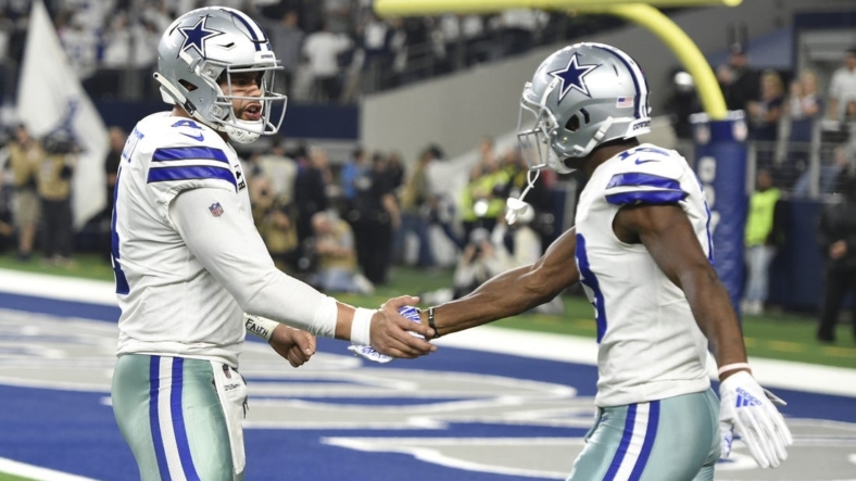Jan 5, 2019; Arlington, TX, USA; Dallas Cowboys quarterback Dak Prescott (4) reacts after throwing a 11 yard touchdown pass to wide receiver Michael Gallup (13) against the Seattle Seahawks in the second quarter in a NFC Wild Card playoff football game at AT&T Stadium. Mandatory Credit: Shane Roper-USA TODAY Sports