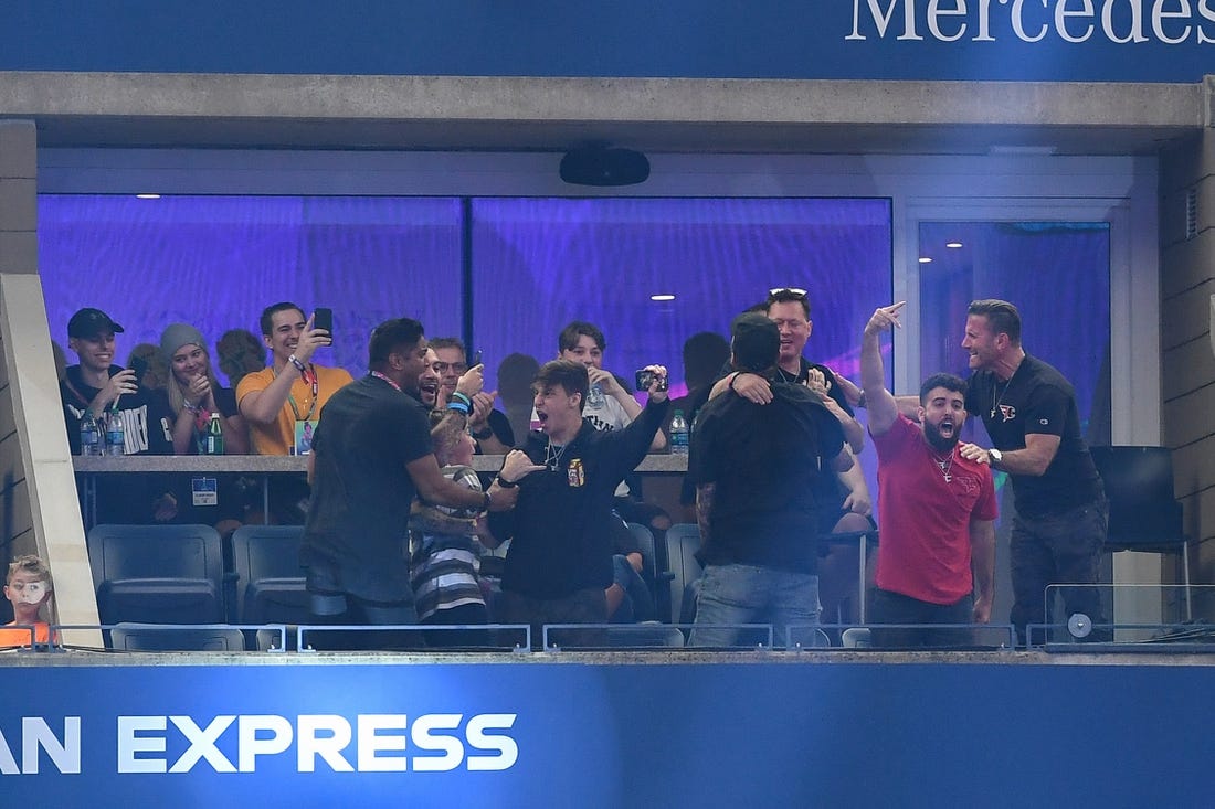 Jul 28, 2019; Flushing, NY, USA; Fans of player Dubs celebrate after his victory in the third round of six at the Fortnite World Cup Finals e-sports event at Arthur Ashe Stadium. Mandatory Credit: Dennis Schneidler-USA TODAY Sports